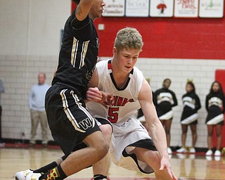 Canfield Tyler Dobrindt(5) tries to evade Harding junior Chris Hughes(23) during the fourth quarter as Warren G. Harding High School takes on Canfield High School at the Canfield High School Gymnasium in Canfield on Tuesday, Jan. 17, 2017. Harding won, 80-62...(Nikos Frazier | The Vindicator)..
