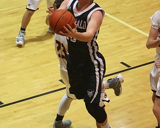 Evan McGoll (10) of McDonald goes in for a layup while being defended by South Range's Jaxon Anderson (23) during the first half of Tuesday nights matchup at South Range High School.  Dustin Livesay  |  The Vindicator  1/17/17  South Range