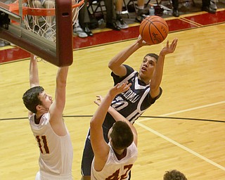 Brayden Poole (30) of McDonald goes up for a shot while being defended by South RangesMike Cunningham (42) and Daniel Ritter (11) during the first half of Tuesday nights matchup at South Range High School.  Dustin Livesay  |  The Vindicator  1/17/17  South Range
