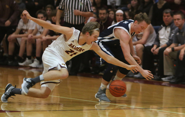 Brandon Youngs of South Range (21) dives after a loose ball with McDonald's Evan McGoll (10) during the first half of Tuesday nights matchup at South Range High School.  Dustin Livesay  |  The Vindicator  1/17/17  South Range.
