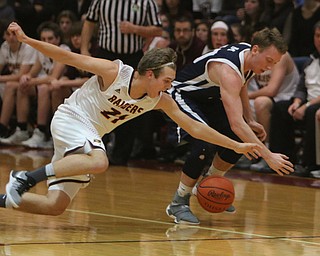 Brandon Youngs of South Range (21) dives after a loose ball with McDonald's Evan McGoll (10) during the first half of Tuesday nights matchup at South Range High School.  Dustin Livesay  |  The Vindicator  1/17/17  South Range.