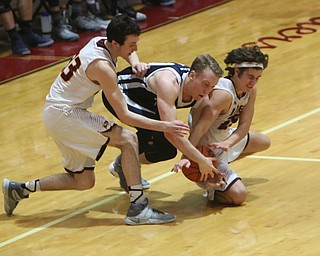 McDonald's Evan McGoll (10) center fights for a loose ball with South Ranges Anthony Ritter (33) and Mark Vennetti (25,right) during the second half of Tuesday nights matchup at South Range High School.  Dustin Livesay  |  The Vindicator  1/17/17  South Range