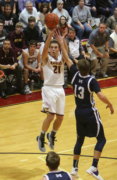 Brandon Youngs of South Range (21) goes up for a shot while being defended by McDonalds Dyland Portolese (13) during the second half of Tuesday nights matchup at South Range High School.  Dustin Livesay  |  The Vindicator  1/17/17  South Range