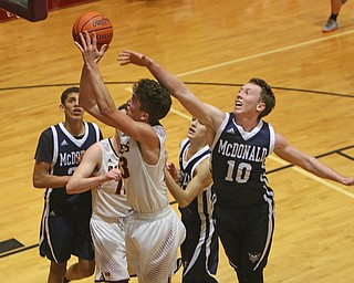 Jaxon Anderson of South Range (23) goes up for a shot while being defended by McDonalds Evan McGoll (10) during the second half of Tuesday nights matchup at South Range High School.  Dustin Livesay  |  The Vindicator  1/17/17  South Range