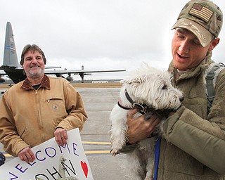 William D. Lewis The Vindicator USAF reserve Lt. John Kirin of Cortland gets a greeting from his dog Roxie after returning from deployment with members of US Air Force reserve unit at YARS  Jan. 18, 2017. At left is his father Tom Kirin also of Cortland.