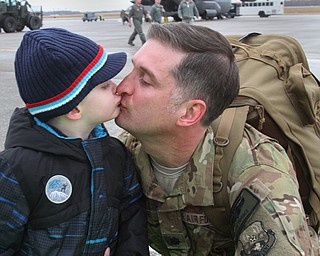William D. Lewis The Vindicator Jay Ference, a member of USAF reserve unit gets a kiss from his son Levi, 5, after returning from deployment with members of US Air Force reserve unit at YARS  Jan. 18, 2017. They are from Fowler.