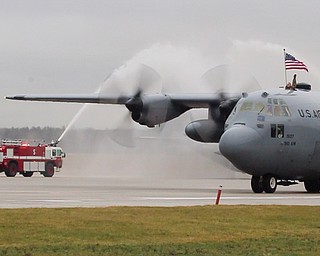 William D. Lewis The Vindicator A C-130 taxis under a stream of water from a fire engine after returning from deployment with members of US Air Force reserve unit at YARS  Jan. 18, 2017.