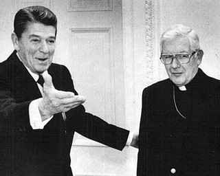 President Ronald Reagan greets Bishop James Malone, new president of the National Conference of Catholic Bishops at the While House.