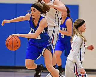 BERLIN CENTER, OHIO - JANUARY 19, 2017: Ashley Totani #11 of Jackson-Milton dribbles away from Gabby Baranowski #23 and Layla Woolf #35 of Western Reserve after forcing a turnover during the first half of their game Thursday night at Western Reserve High School. DAVID DERMER | THE VINDICATOR
