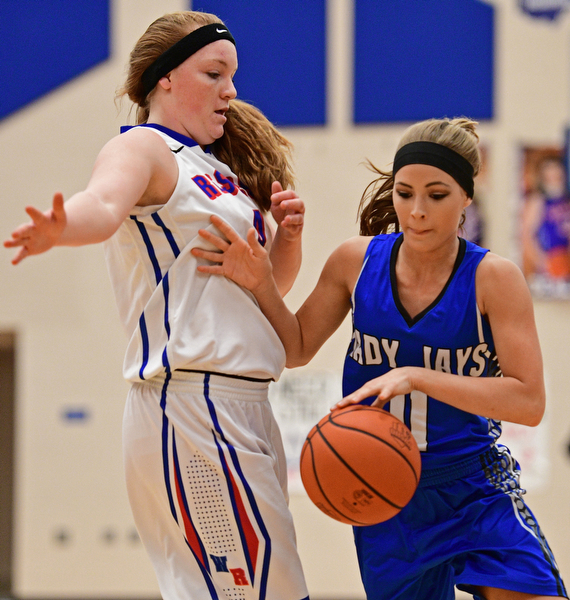 BERLIN CENTER, OHIO - JANUARY 19, 2017: Ashley Totani #11 of Jackson-Milton creates some space while driving on Alexis Hughes #4 of Western Reserve during the first half of their game Thursday night at Western Reserve High School. DAVID DERMER | THE VINDICATOR