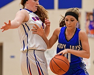 BERLIN CENTER, OHIO - JANUARY 19, 2017: Ashley Totani #11 of Jackson-Milton creates some space while driving on Alexis Hughes #4 of Western Reserve during the first half of their game Thursday night at Western Reserve High School. DAVID DERMER | THE VINDICATOR