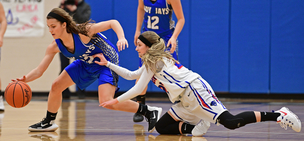 BERLIN CENTER, OHIO - JANUARY 19, 2017: Michaelina Terranova #22 of Jackson-Milton gains control of the ball while Gabby Baranowski #23 of Western Reserve dives on the floor in an attempt to force a turnover during the first half of their game Thursday night at Western Reserve High School. DAVID DERMER | THE VINDICATOR