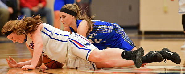 BERLIN CENTER, OHIO - JANUARY 19, 2017: Alexis Hughes #4 of Western Reserve falls on the floor to attempt to regain possession of the ball after Kaitlyn Totani #12 of Jackson-Milton knocked the ball free during the first half of their game Thursday night at Western Reserve High School. DAVID DERMER | THE VINDICATOR