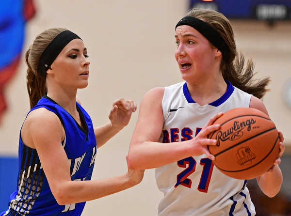 BERLIN CENTER, OHIO - JANUARY 19, 2017: Ashley Totani #11 of Jackson-Milton pressures Laura Sigworth #21 of Western Reserve during the first half of their game Thursday night at Western Reserve High School. DAVID DERMER | THE VINDICATOR