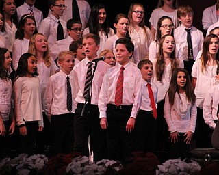 Neighbors | Abby Slanker.Canfield Village Middle School’s sixth-grade students Ryan Schneider, left, and Stephen Maszczak paired up for a duet during “Jingle Bell Boogie” at the school’s annual Winter Choir Concert Dec. 5.