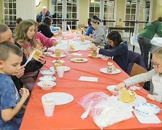 Neighbors | Alexis Bartolomucci.Guests created houses out of graham crackers, frosting and several other sweets during a program at the Poland library on Dec. 20.