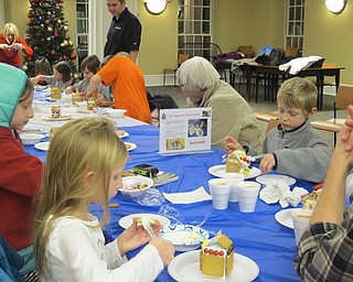 Neighbors | Alexis Bartolomucci.Children used different candies and sweets to decorate their graham cracker houses they made at the Poland library on Dec. 20.