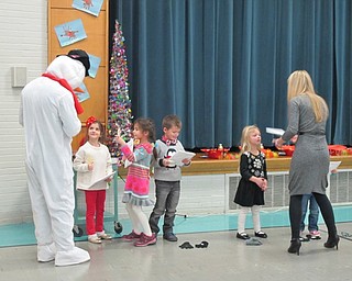 Neighbors | Alexis Bartolomucci.Students lined up after their performance to get a sucker from Frosty the Snowman at North Preschool on Dec. 22.