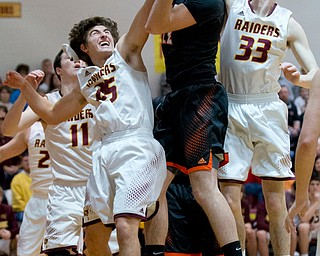 MICHAEL G TAYLOR | THE VINDICATOR- 01-20-17 - Basketball -1st qtr, South Range's #25 Mark Vennetti and #33 Anthony Ritter stop Springfield's #22 Pat Flara shot attempt. New Middletown Springfield Tigers vs South Range Raiders at South Range High School in South Range, OH