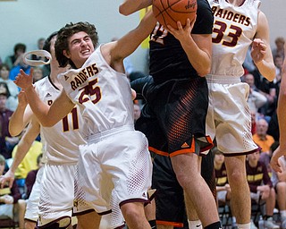 MICHAEL G TAYLOR | THE VINDICATOR- 01-20-17 - Basketball -1st qtr, South Range's #25 Mark Vennetti and #33 Anthony Ritter stop Springfield's #22 Pat Flara shot attempt. New Middletown Springfield Tigers vs South Range Raiders at South Range High School in South Range, OH