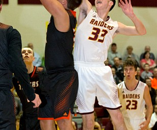MICHAEL G TAYLOR | THE VINDICATOR- 01-20-17 - Basketball -1st qtr, South Range's #33 Anthony Ritter blocks the shot of  Springfield's #30 Jake Ford. New Middletown Springfield Tigers vs South Range Raiders at South Range High School in South Range, OH
