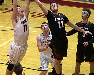 MICHAEL G TAYLOR | THE VINDICATOR- 01-20-17 - Basketball - 3rd qtr,  South Range's #11 Daniel Ritter grabs the rebound away Springfield's #22 Pat Flara. New Middletown Springfield Tigers vs South Range Raiders at South Range High School in South Range, OH