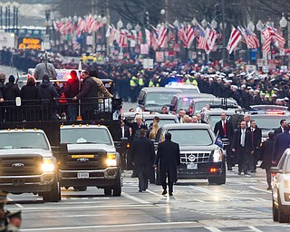 President Donald Trump and his wife Melania, center, walk during the Inaugural Parade on Pennsylvania Avenue, in Washington, Friday, Jan. 20, 2017. (AP Photo/Cliff Owen)