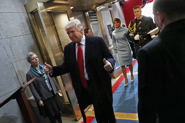President Donald Trump, followed by first lady Melania Trump. gives a thumbs-up as they on the West Front of the Capitol in Washington, Friday, Jan. 20, 2017. (Win McNamee/Pool Photo via AP)