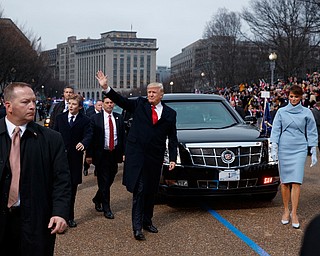 President Donald Trump and first lady Melania Trump walk near the White House in the inaugural parade after he was sworn in as the 45th President of the United States, Friday, Jan. 20, 2017, in Washington. (AP Photo/Evan Vucci, Pool)