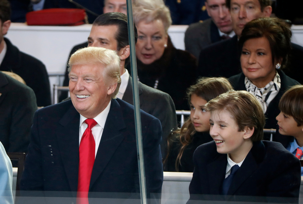 President Donald Trump smiles with his son Barron as they view the 58th Presidential Inauguration parade for President Donald Trump in Washington. Friday, Jan. 20, 2017 (AP Photo/Pablo Martinez Monsivais)