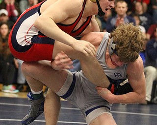 Jax Leonard(grey) of Louisville grabs hold of Andrew Fairbanks(red) of Fitch's leg at the Josh Hephner Memorial Wrestling Tournament at Austintown Fitch High School Gymnasium in Austintown on Saturday, Jan. 21, 2017. Leonard won by points...(Nikos Frazier | The Vindicator)..