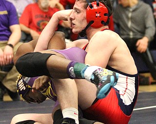 Michael Ferree(red) of Fitch rests for a second as he holds Braxton Freeman(purple) of Jackson at the Josh Hephner Memorial Wrestling Tournament at Austintown Fitch High School Gymnasium in Austintown on Saturday, Jan. 21, 2017. Feree won by points...(Nikos Frazier | The Vindicator)..