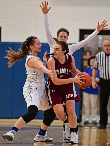 POLAND, OHIO - JANUARY 21, 2017: Jenna Vivo #5 of Boardman looks to pass the ball while being pressured by Emily Melnek #42 and Bella Gajdos #23 of Poland during the second half of their game Saturday afternoon at Poland High School. DAVID DERMER | THE VINDICATOR