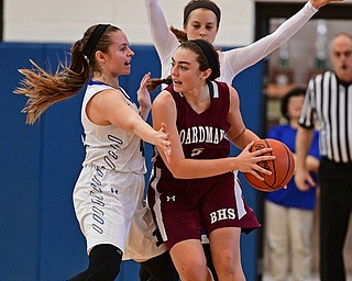 POLAND, OHIO - JANUARY 21, 2017: Jenna Vivo #5 of Boardman looks to pass the ball while being pressured by Emily Melnek #42 and Bella Gajdos #23 of Poland during the second half of their game Saturday afternoon at Poland High School. DAVID DERMER | THE VINDICATOR