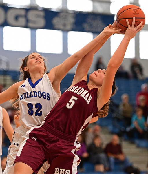 POLAND, OHIO - JANUARY 21, 2017: Juliana Blangero #32 of Poland attempts to knock the ball free from the grasp of Jenna Vivo #5 of Boardman during the second half of their game Saturday afternoon at Poland High School. DAVID DERMER | THE VINDICATOR