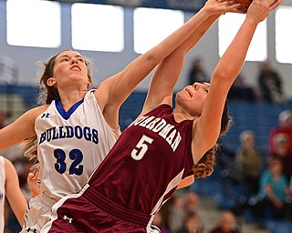 POLAND, OHIO - JANUARY 21, 2017: Juliana Blangero #32 of Poland attempts to knock the ball free from the grasp of Jenna Vivo #5 of Boardman during the second half of their game Saturday afternoon at Poland High School. DAVID DERMER | THE VINDICATOR