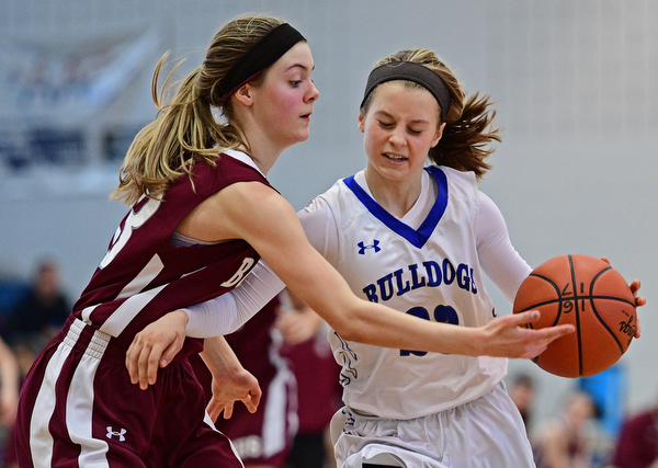 POLAND, OHIO - JANUARY 21, 2017: Bella Gajdos #23 of Poland drives on Cate Green #13 of Boardman during the second half of their game Saturday afternoon at Poland High School. DAVID DERMER | THE VINDICATOR