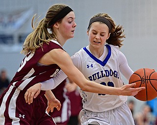 POLAND, OHIO - JANUARY 21, 2017: Bella Gajdos #23 of Poland drives on Cate Green #13 of Boardman during the second half of their game Saturday afternoon at Poland High School. DAVID DERMER | THE VINDICATOR