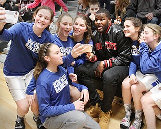 William D. Lewis The Vindicator Former OSU standout Cardale Jones poses for a group shot with members of the McDonald HS Jr High girls basketball team. One of the members Anna Booth(8th grade) was recently was diagnosed with cancer. Jones visited Mondays McDonald at Mineral Ridge game to show support for Anna who didn't attend the game. Jones visited her at her McDonald home before the game.