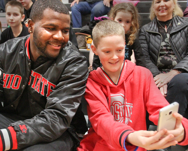 William D. Lewis The Vindicator Former OSU standout Cardale Jones poses for a shot  McDonald Natahn Sierra, 12, a classmate of  Anna Booth(8th grade) was recently was diagnosed with cancer. Jones visited Mondays McDonald at Mineral Ridge game to show support for Anna who didn't attend the game. Jones visited her at her McDonald home before the game.