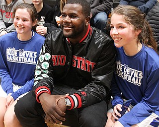 William D. Lewis The Vindicator Former OSU standout Cardale Jones poses for a  shot with members of the McDonald HS Jr High girls basketball team Emily Pratt, left, and Brooke Lewis. One of the team members Anna Booth(8th grade) was recently was diagnosed with cancer. Jones visited Mondays McDonald at Mineral Ridge game to show support for Anna who didn't attend the game. Jones visited her at her McDonald home before the game.