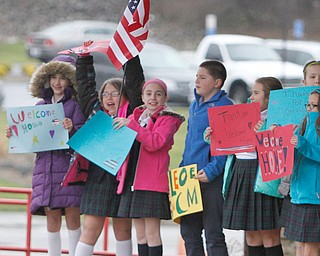        ROBERT K. YOSAY  | THE VINDICATOR..St Christines welcomed back  Jason Davis after serving 7 months in Bahrain.  Jason suprised his son Jason Jr. a Kindergarten student in his class but not before the whole school made posters, waved flags, and clapped.. shouted USA and sang patriotic songs.. Lining the hallways to his sons room  Moms Name is Jana (ok)  all of Austintown