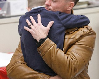        ROBERT K. YOSAY  | THE VINDICATOR..St Christines welcomed back  Jason Davis after serving 7 months in Bahrain.  Jason suprised his son Jason Jr. a Kindergarten student in his class but not before the whole school made posters, waved flags, and clapped.. shouted USA and sang patriotic songs.. Lining the hallways to his sons room  Moms Name is Jana (ok)  all of Austintown