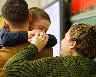        ROBERT K. YOSAY  | THE VINDICATOR..St Christines welcomed back  Jason Davis after serving 7 months in Bahrain.  Jason suprised his son Jason Jr. a Kindergarten student in his class but not before the whole school made posters, waved flags, and clapped.. shouted USA and sang patriotic songs.. Lining the hallways to his sons room  Moms Name is Jana (ok)  all of Austintown