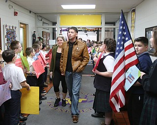        ROBERT K. YOSAY  | THE VINDICATOR..St Christines welcomed back  Jason Davis after serving 7 months in Bahrain.  Jason suprised his son Jason Jr. a Kindergarten student in his class but not before the whole school made posters, waved flags, and clapped.. shouted USA and sang patriotic songs.. Lining the hallways to his sons room  Moms Name is Jana (ok)  all of Austintown