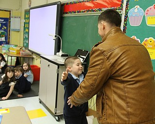        ROBERT K. YOSAY  | THE VINDICATOR..St Christines welcomed back  Jason Davis after serving 7 months in Bahrain.  Jason suprised his son Jason Jr. a Kindergarten student in his class but not before the whole school made posters, waved flags, and clapped.. shouted USA and sang patriotic songs.. Lining the hallways to his sons room  Moms Name is Jana (ok)  all of Austintown