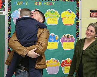        ROBERT K. YOSAY  | THE VINDICATOR..St Christines welcomed back  Jason Davis after serving 7 months in Bahrain.  Jason suprised his son Jason Jr. a Kindergarten student in his class but not before the whole school made posters, waved flags, and clapped.. shouted USA and sang patriotic songs.. Lining the hallways to his sons room  Moms Name is Jana (ok)  all of Austintown