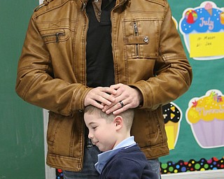        ROBERT K. YOSAY  | THE VINDICATOR..St Christines welcomed back  Jason Davis after serving 7 months in Bahrain.  Jason suprised his son Jason Jr. a Kindergarten student in his class but not before the whole school made posters, waved flags, and clapped.. shouted USA and sang patriotic songs.. Lining the hallways to his sons room  Moms Name is Jana (ok)  all of Austintown