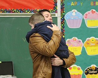        ROBERT K. YOSAY  | THE VINDICATOR..St Christines welcomed back  Jason Davis after serving 7 months in Bahrain.  Jason suprised his son Jason Jr. a Kindergarten student in his class but not before the whole school made posters, waved flags, and clapped.. shouted USA and sang patriotic songs.. Lining the hallways to his sons room  Moms Name is Jana (ok)  all of Austintown