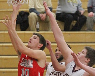 William D. Lewis The Vindicator  LaBrae's Logan Kiser (1o) drives past Liberty's Kevin Code(4) and Derek Gilcher(20) during Jan 24, 2017 action at Liberty.